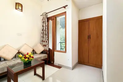 a living room with a couch and a table at Le Celestium in Munnar