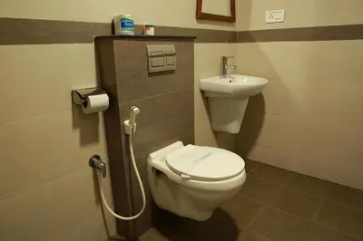 a bathroom with a toilet and a sink at Le Celestium in Munnar