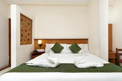 a bedroom with swan towels on a bed at Le Celestium in Munnar