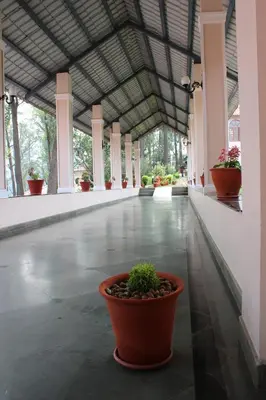 a large hallway with potted plants in a building at KTDC Tea county in Munnar