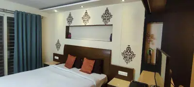 a bedroom with a bed in a room with a window at Happy Vibes studio flats - service apartment in Mysore