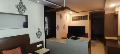 a room with a desk and a tv in a room at Happy Vibes studio flats - service apartment in Mysore