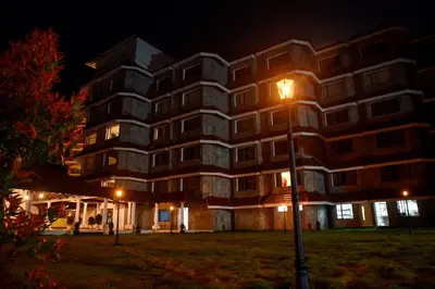 a building at night with a street light in front at THE PEARL VIEW HOTEL in Mulappilangād