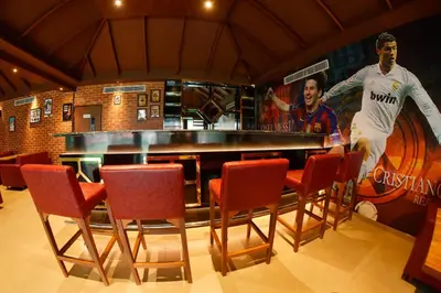 a bar with a table and chairs in a room at THE PEARL VIEW HOTEL in Mulappilangād