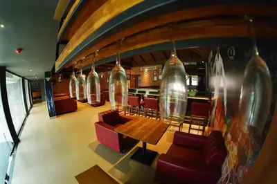 a restaurant with a table and chairs and a bar at THE PEARL VIEW HOTEL in Mulappilangād
