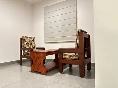 two chairs and a table in a room at Nexstay Kassaba Inn in Kozhikode