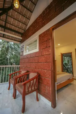 a brick wall with two benches on a balcony at Redstone Villa in Tāzhekkod