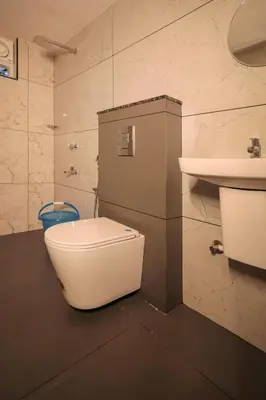 a bathroom with a toilet and a sink at Redstone Villa in Tāzhekkod