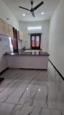 a large kitchen with a ceiling fan in a room at Sandiago Villa 2 Bhk House in Ooty