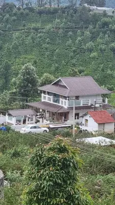 a large house with cars parked in front of it at Sandiago Villa 2 Bhk House in Ooty
