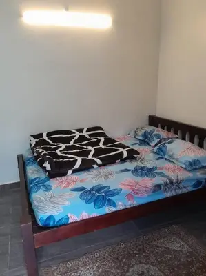 a bed with a zebra blanket on top of it at Ohm Shanthi Kudil in Kodaikānāl
