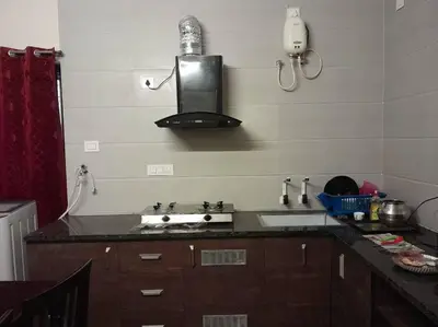 a kitchen with a sink and a counter top at Ohm Shanthi Kudil in Kodaikānāl