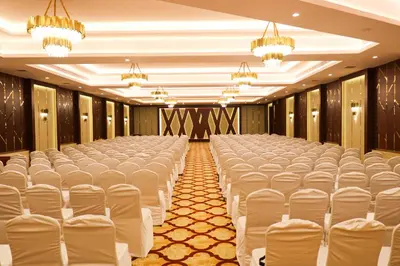 a row of chairs in a banquet hall at Jenneys Residency in Coimbatore