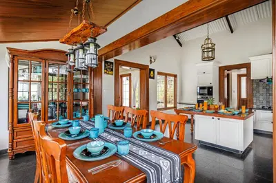a kitchen and dining room with a table and chairs at The Winterfel in Yedapalli