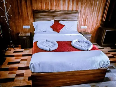a bedroom with two beds with white sheets and pillows at Don's River Valley Jungle Resort in Marayoor