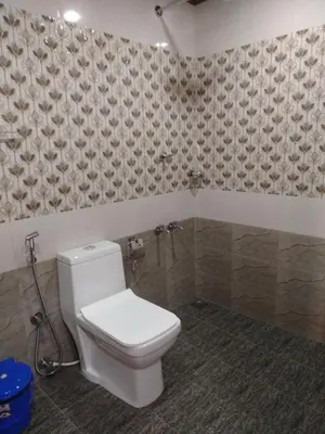 a bathroom with a white toilet in a room at Don's River Valley Jungle Resort in Marayoor