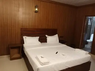 a bedroom with a bed with two towels on it at JK Nature Stay Resorts in Kanthalloor