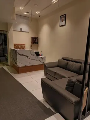 a living room with a couch and a counter at SREENARAYANA TOURIST HOME in Guruvāyūr