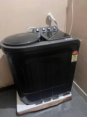 a black toaster sitting on a stand next to a wall at Chaithanya Residency Near to NIT Kozhikode in Kunnamangalam