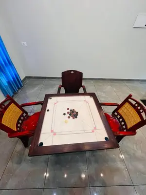 a ping pong table with two chairs in a room at Chaithanya Residency Near to NIT Kozhikode in Kunnamangalam
