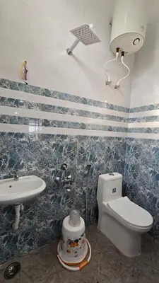 a bathroom with a toilet and a sink at Sandy Castle Villa 3 Bhk Homestay in Ooty
