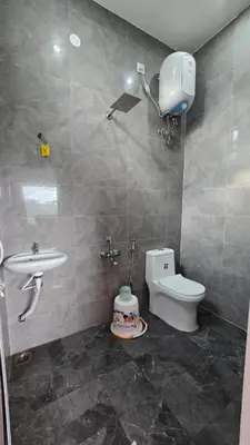 a bathroom with a toilet and a sink at Sandy Castle Villa 3 Bhk Homestay in Ooty