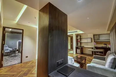 a living room with a fireplace and a living room at Regenta Central Javaji Mysore in Mysore
