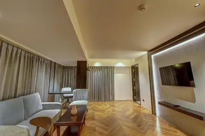 a living room with a couch and a table at Regenta Central Javaji Mysore in Mysore