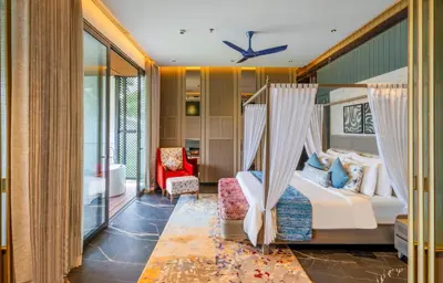 a bedroom with a bed and a swing at Flora Misty Falls Athirappilly in Athirappilly