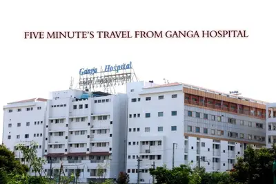 a white building with the words five minutes travel from gangena hospital at PRANOV RESIDENCY-Luxury in Coimbatore