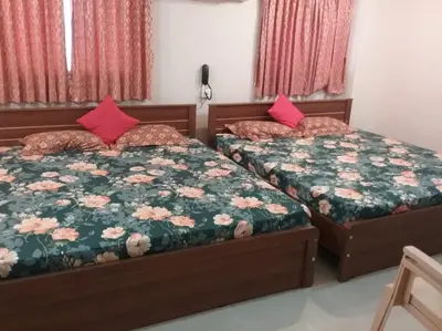 two beds in a room with two beds sidx sidx sidx at PRANOV RESIDENCY-Luxury in Coimbatore