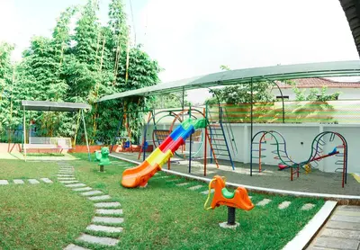 a park with a playground with a slide and swings at Agasthya Private Pool & Park villa in Sultan Bathery