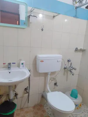 a bathroom with a toilet and a sink at Misty Moonrise in Kūkkāl