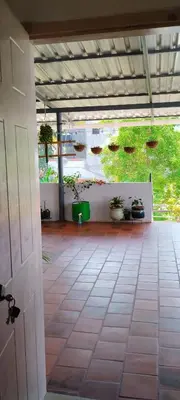 an open patio with potted plants on the wall at Karimbummel House- A room with spacious Balcony in Mysore