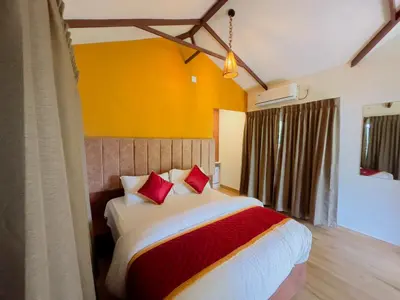 a bedroom with a large bed with red pillows at Coffee Cradle Wayanad Luxuorios Private Tree House - Inside 2 Acre Coffee Plantation in Mananthavady