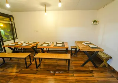 a group of tables with plates on them in a room at Munnar Majestic Resort with Pool in Munnar