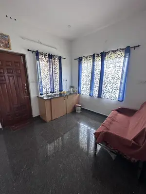 a bedroom with a bed and two large windows at Sandy 4 Bhk Homestay - Only Adults Allowed in Ooty