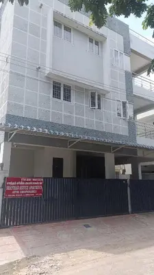 a large white building with a sign in front of it at Shantham Service Apartments, Indumanagar, Coimbatore in Coimbatore