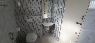 a bathroom with a sink and a toilet and a mirror at Shantham Service Apartments, Indumanagar, Coimbatore in Coimbatore