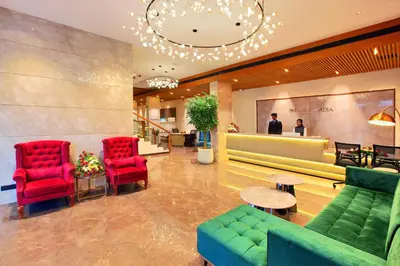 a lobby with red chairs and a waiting room at PARK RESIDENCY ARCADIA in Alwaye