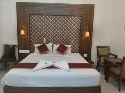 a bedroom with a bed with two towels on it at Grand Milestone in Mysore