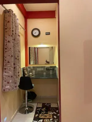 a hallway with a mirror and a chair in a room at Four Seasons Homestay single room in Madikeri