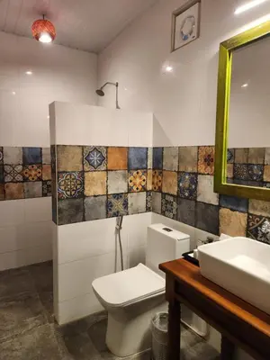 a bathroom with a toilet and a sink and a mirror at Welbeck Vintage By Oxygen Resorts in Ooty