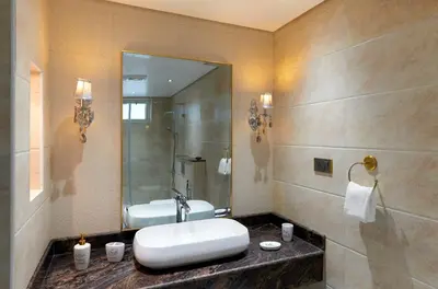 a bathroom with a sink and a mirror at Clouds Nest By Aanvis Inn in Ooty