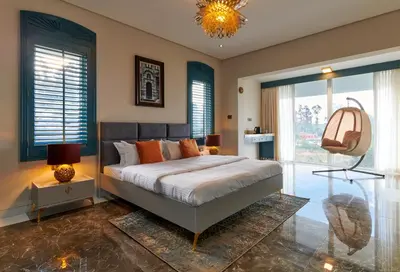 a bedroom with a large bed and a chandelier at Clouds Nest By Aanvis Inn in Ooty