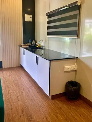 a kitchen with a sink and a counter top at WHOOSH HOMES in Cochin