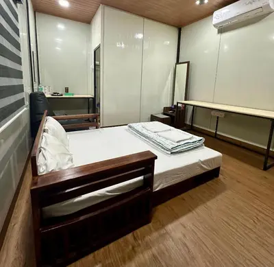 a hospital room with a bed and a mirror at WHOOSH HOMES in Cochin