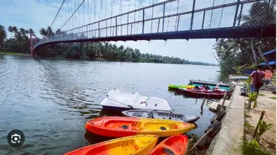 a group of boats on the water under a bridge at Furnished 2 BHK Family Apartments near Triprayar Shree Rama Temple - Beevees Homes Thriprayar in Thanniyam