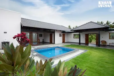 an image of a villa with a swimming pool at StayVista at Ava - The Country House with Breakfast & Miniature Golf in Mysore