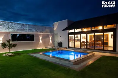 a house with a swimming pool in the yard at StayVista at Ava - The Country House with Breakfast & Miniature Golf in Mysore